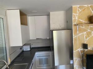 a kitchen with a stainless steel refrigerator at Cortijo LOS MIRADORES in Vélez Blanco