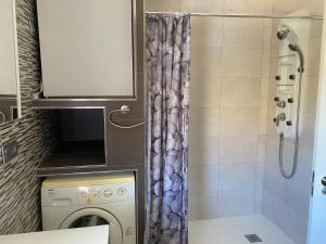 a small bathroom with a washing machine and a shower at Cortijo LOS MIRADORES in Vélez Blanco +20 photos