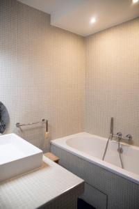 a bathroom with a tub and a sink at Duplex rooftop vue Tour Eiffel in Bagnolet +38 photos