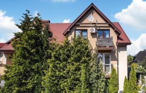 a house with trees in front of it at Gorgeous Apartment In Jastarnia in Jastarnia +7 photos