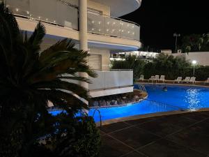 a building with a swimming pool at night at Quiet Salou Beach Front with parking in Salou