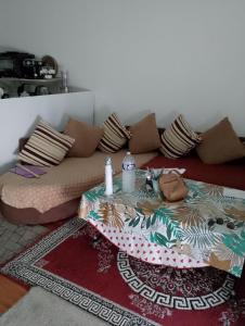 a living room with a couch with a table at Genicar in Lormont