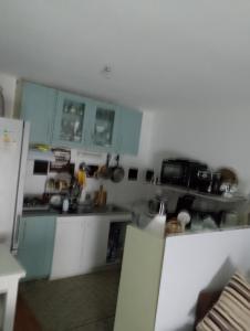 a kitchen with blue cabinets and a counter top at Genicar in Lormont +1 photo