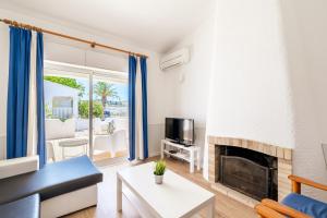 a living room with a couch and a fireplace at Monte Sao Pedro - Villa in Luz