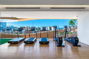 a gym with several treadmills and a view of a city at SOHO PV - 1007 Best and Brand New Condo in Puerto Vallarta