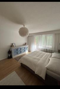 a bedroom with a large bed and a window at Rooftop ink Parking in Lucerne