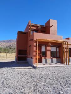 a building in the middle of a desert at El Alfarero de Maimará in Maimará