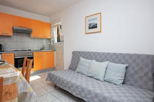 a living room with a couch in a kitchen at Apartment Tisno 4295d in Tisno +21 photos