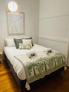 a bedroom with a large bed with two towels on it at Country Charmer On Albert in The Range