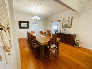 a dining room with a wooden table and chairs at Country Charmer On Albert in The Range +11 photos
