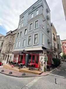 a building on a street with tables in front of it at Elegance House Hotel in Istanbul