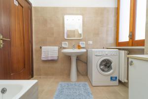 a bathroom with a sink and a washing machine at Villa Incoronata in Agerola