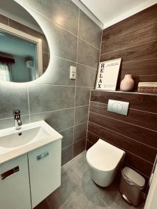 a bathroom with a toilet and a sink and a mirror at A casa do Boubelo in Vimioso +30 photos