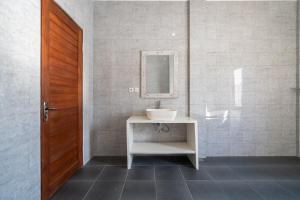 a bathroom with a sink and a mirror at Beatrix Villa in Ubud +3 photos