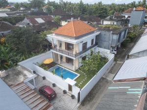 an aerial view of a house with a swimming pool at Beatrix Villa in Ubud