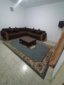 a living room with a couch and a table on a rug at Apartments in Djerba
