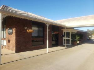 a brick building with awning on a street at Balranald Motor Inn in Balranald +3 photos