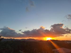 a sunset from the balcony of a house at La plus belle vue de Ducos ! in Ducos