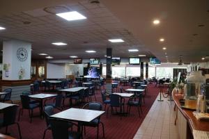 an empty dining room with tables and chairs at Corowa Golf Club Motel in Corowa