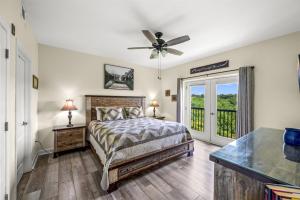 a bedroom with a bed and a ceiling fan at Smoky Mountain View Condo- Hot Tub, Indoor Pool, Walking Path, Playground in Pigeon Forge