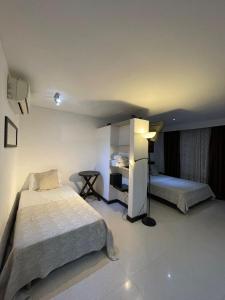 Voodi või voodid majutusasutuse Hotel Plaza Norte Cali toas