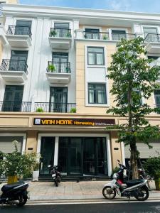 two motorcycles parked in front of a building at Vinh Home in Ðông Hà