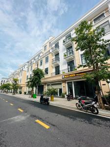 a building with motorcycles parked on the side of a street at Vinh Home in Ðông Hà +47 photos
