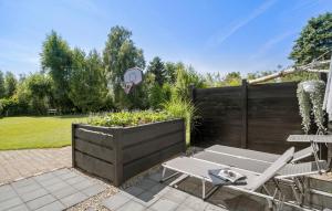 a patio with a table and chairs and a basketball hoop at 3 Bedroom Stunning Home In Højby in Højby +12 photos
