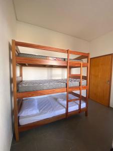 two bunk beds in a room with a door at Casa Elementus Preá in Prea +17 photos