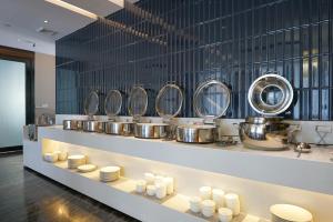 a row of pots and pans in a kitchen at Paco Hotel Guangzhou Baiyun Airport Liantang Metro in Huadu
