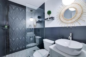 a bathroom with a sink and a toilet and a mirror at Green Acres Nature Escape in Long Pond