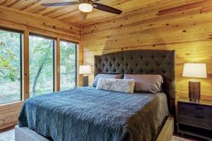 a bedroom with a bed and a ceiling fan at Waterside Cottage with Hot Tub in Innsbrook