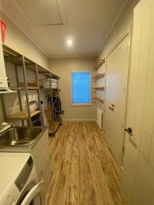 a kitchen with a sink and a wooden floor at Cardrona Mountain Villa in Cardrona