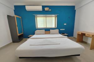Postel nebo postele na pokoji v ubytování Hotel Sai Inn Executive