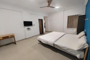 Postel nebo postele na pokoji v ubytování Hotel Sai Inn Executive