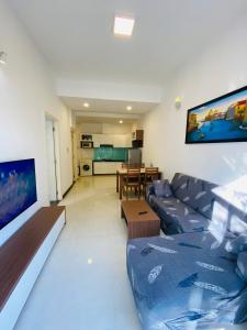 a living room with a couch and a table at Pearl Service Apartment in Ho Chi Minh City