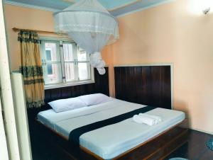 Ένα ή περισσότερα κρεβάτια σε δωμάτιο στο Pan guest house Donkhone
