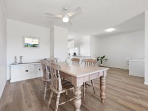 a kitchen and dining room with a table and chairs at Seaside Getaway on Kingscliff Beach in Kingscliff +16 photos
