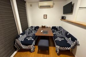 a room with a table with a laptop on it at Sumuide Terrace SHIDO in Nago