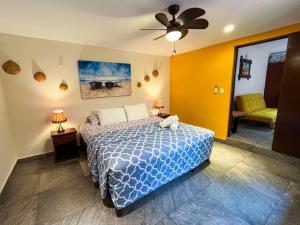 a bedroom with a bed and a ceiling fan at Cande's Apartments in Isla Mujeres