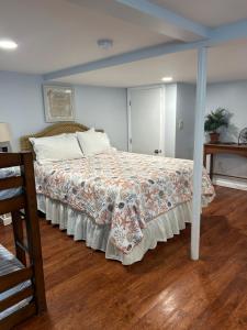 a bedroom with a large bed with a blanket on it at Sea Gem in Old Orchard Beach