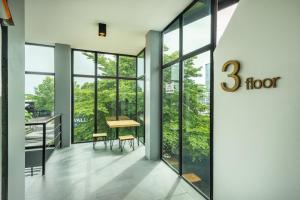 a rendering of a floor lobby with windows at SHIN Hotel Nimman ChiangMai in Chiang Mai