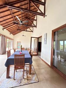 a dining room with a blue table and chairs at Villa Ponjok Batu Residence in Bukti