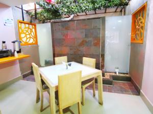 a table and chairs in a kitchen with plants at Hotel Lleras Express in Medellín