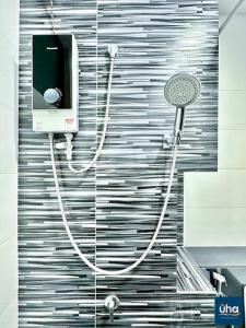 a bathroom with a shower with a hair dryer on a wall at Citywood by RR JBcity in Johor Bahru +58 photos