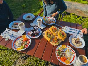 a picnic table with plates of food on it at Qaldea Resort in Ushguli