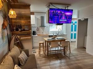 a kitchen with a couch and a table with chairs at Studio Apartment 5 minutes from beach in St Petersburg