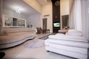 a living room with two beds and a table and chairs at Private Villa in Kollam with Pool in Kollam