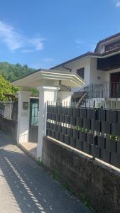 a white house with a fence in front of it at BB La Collina Botticino in Botticino Sera