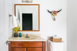 a bathroom with a sink and a mirror at Grand Loft ON THEE Broadway Strip in Nashville